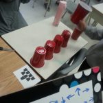 Students created programs for stacking cups using agreed-upon symbols and sequential steps