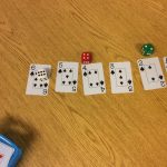 Each person rolls the die and order their die (can use cards or number to assist). Player with die in middle wins.