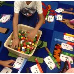 Students using snap cubes to solve addition sentences